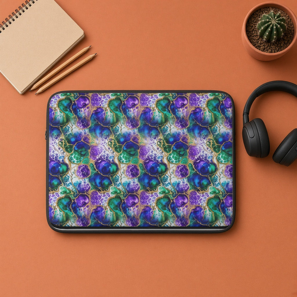 Peacock Acrylic Pour Cells laptop sleeve flat lay on terracotta with headphones and a notebook
