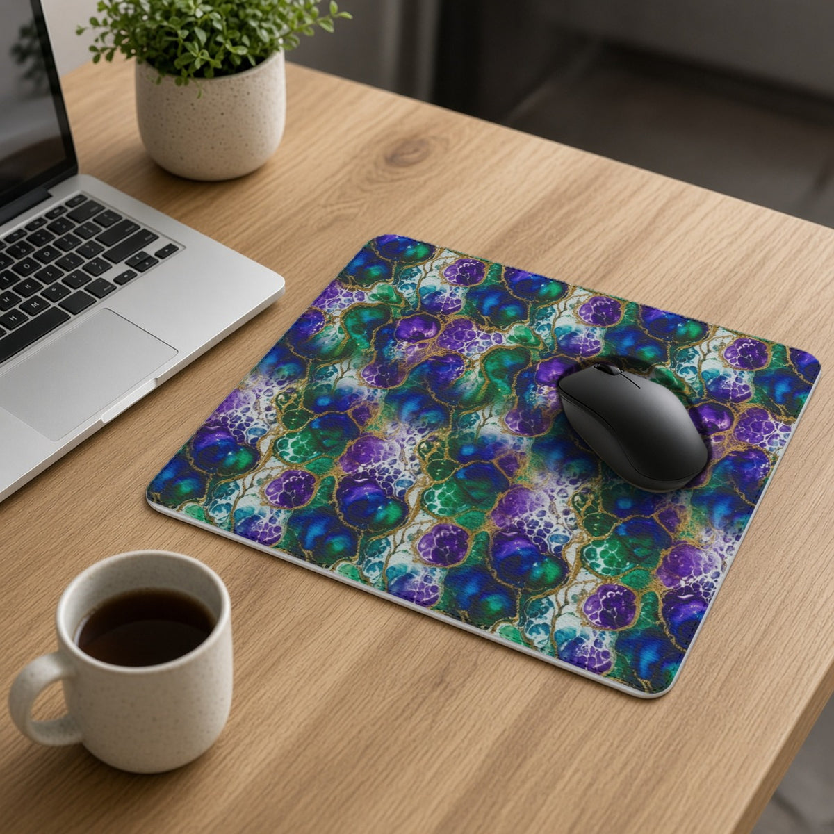 Peacock Acrylic Pour Cells vegan leather mouse mat on an oak desk with a laptop, mouse and coffee
