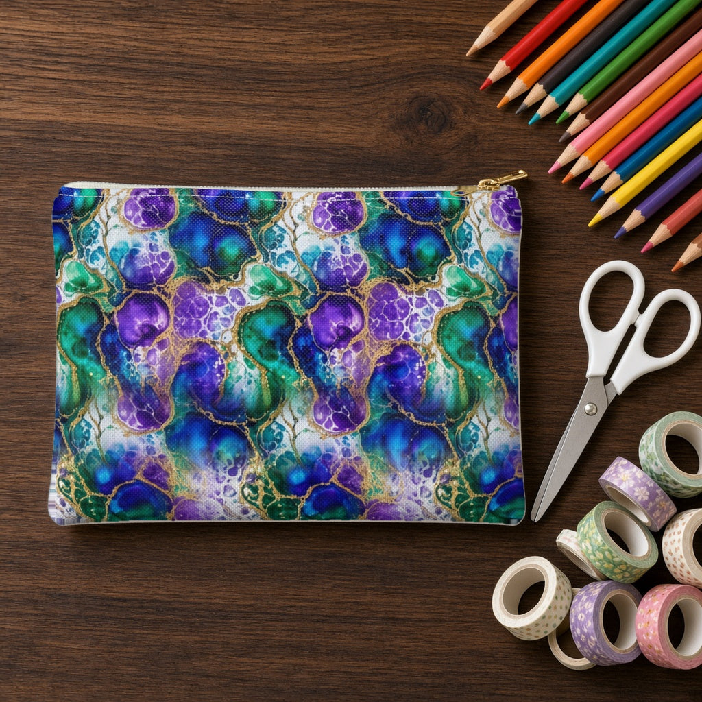 Peacock Acrylic Pour Cells zip accessory pouch on a walnut desk with coloured pencils and washi tape