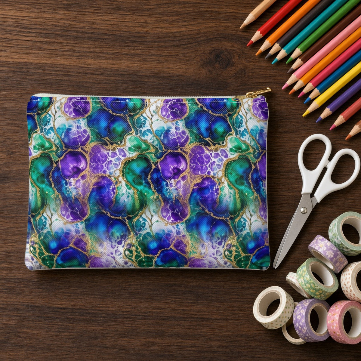 Peacock Acrylic Pour Cells zip accessory pouch on a walnut desk with coloured pencils and washi tape