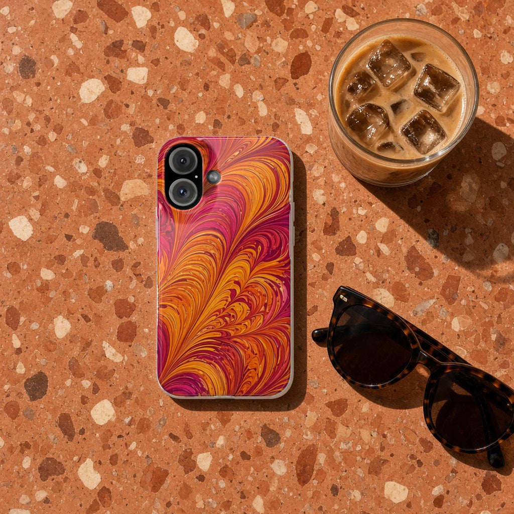 Sunset Feather Marbling slim phone case on terrazzo with an iced coffee and sunglasses