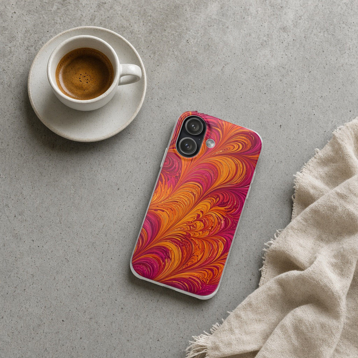 Sunset Feather Marbling flexi phone case on a concrete cafe table with an espresso