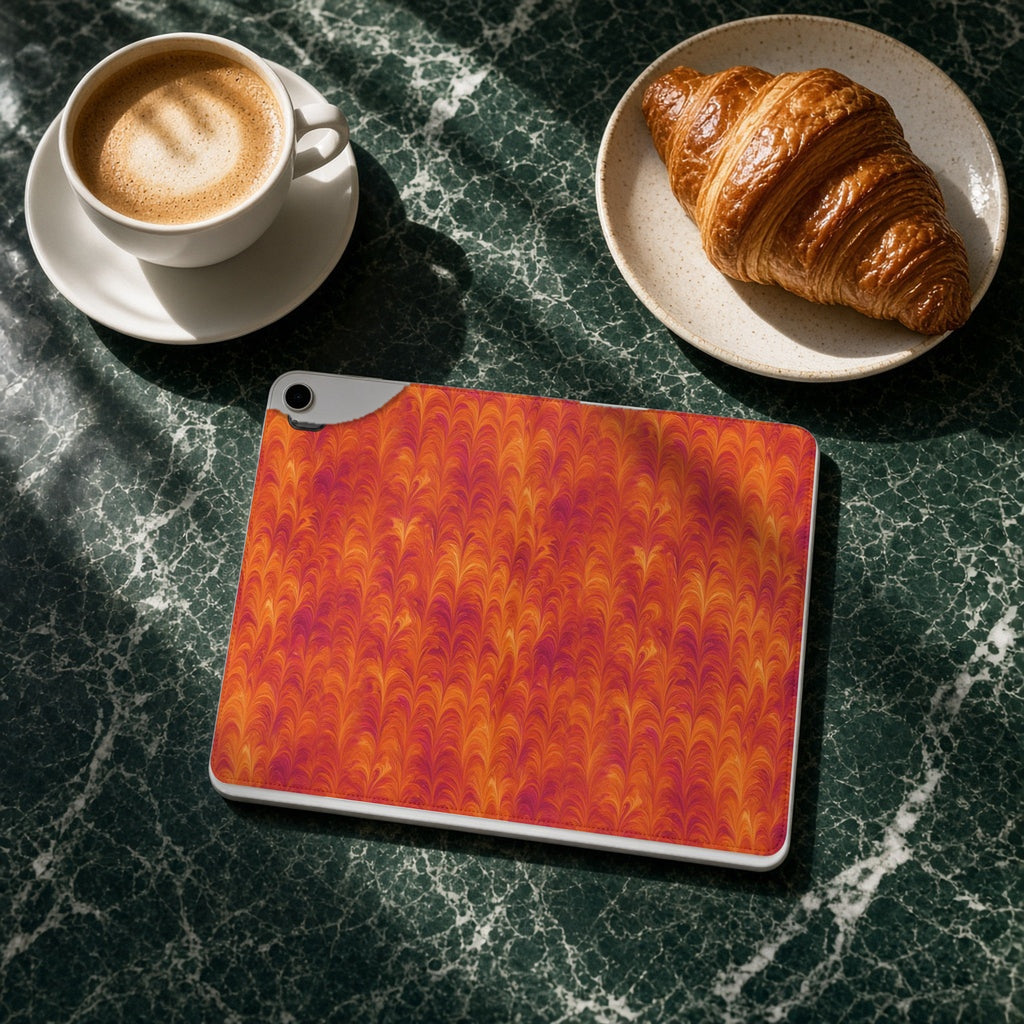 Sunset Feather Marbling iPad folio case on a green marble cafe table with a cappuccino