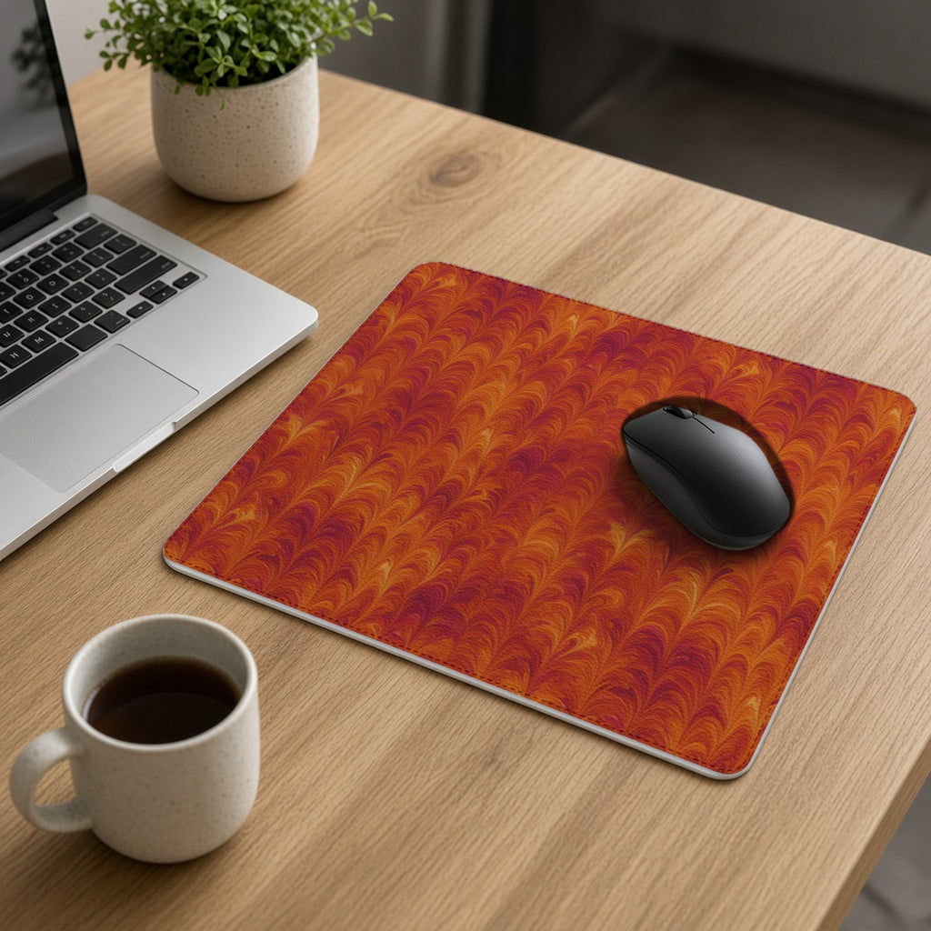 Sunset Feather Marbling vegan leather mouse mat on an oak desk with a laptop, mouse and coffee