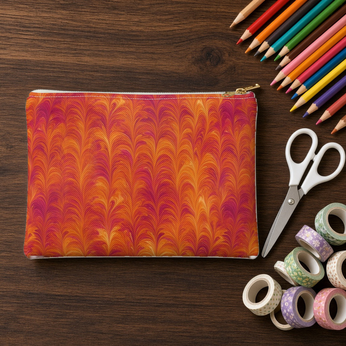 Sunset Feather Marbling zip accessory pouch on a walnut desk with coloured pencils and washi tape