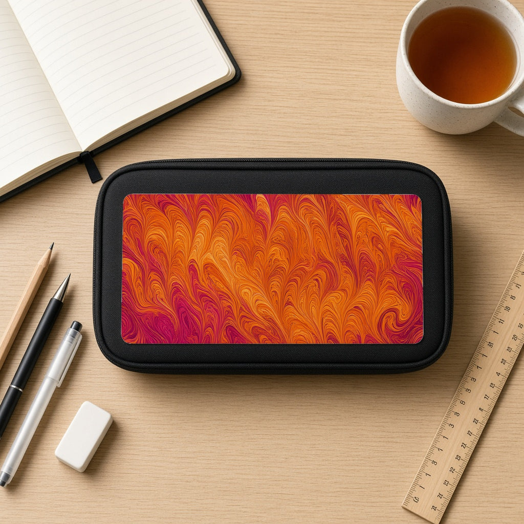 Sunset Feather Marbling pencil case on a wooden desk with notebook, pens and a cup of tea