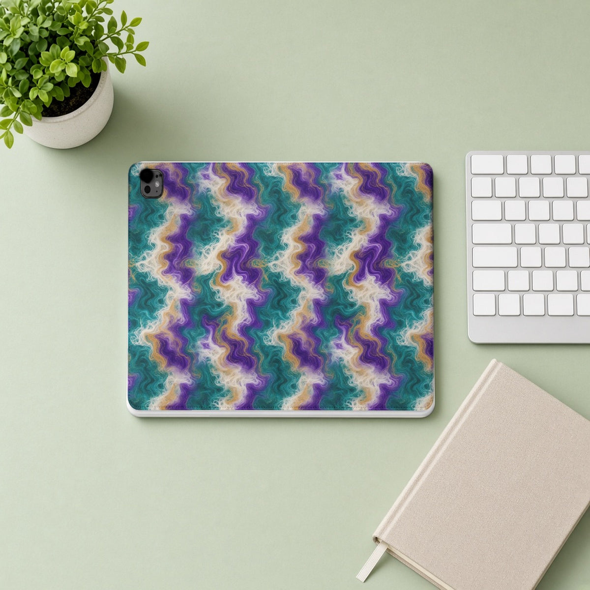 Peacock Resin Wave iPad folio case from above on a sage desk with a keyboard and notebook