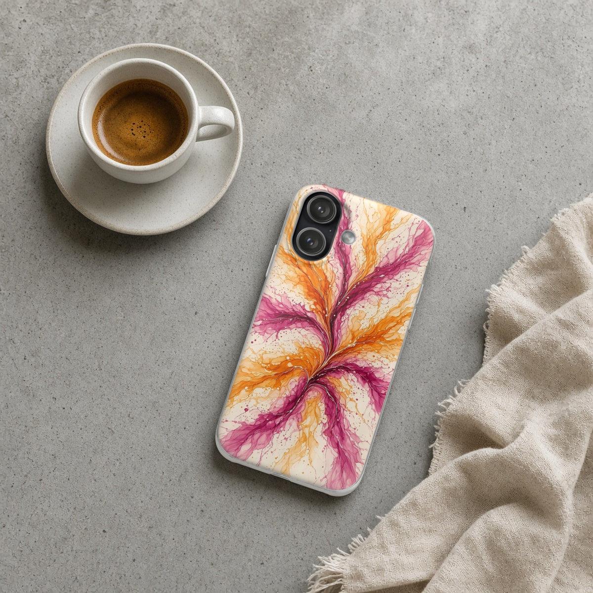 Sunset Ink Branches flexi phone case on a concrete cafe table with an espresso
