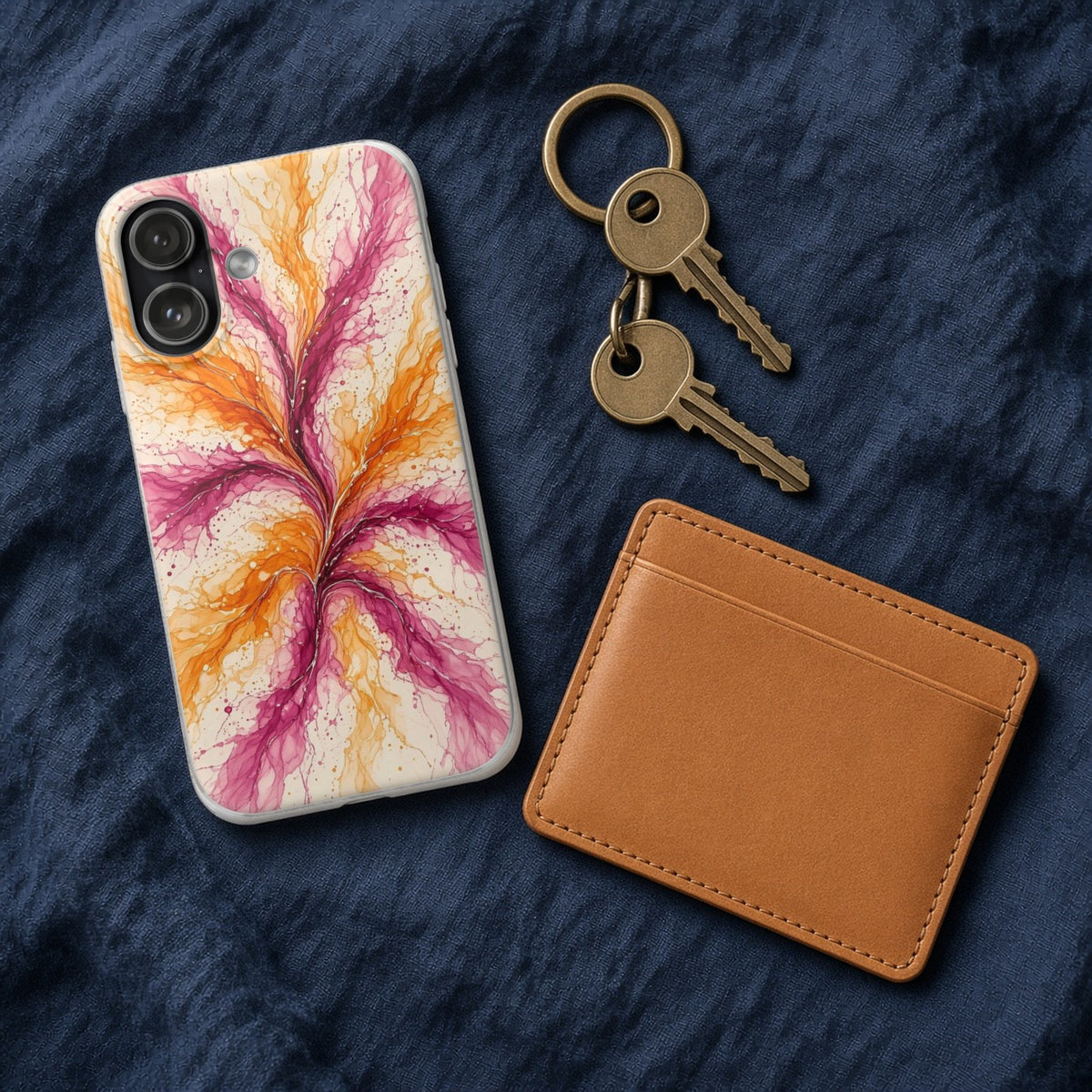 Sunset Ink Branches flexi phone case on navy linen with keys and a leather wallet