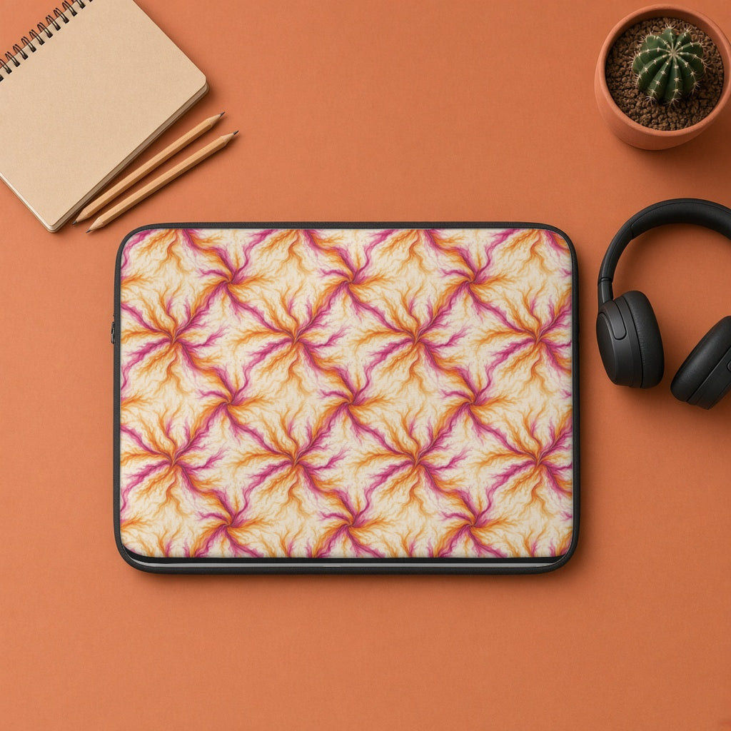 Sunset Ink Branches laptop sleeve flat lay on terracotta with headphones and a notebook