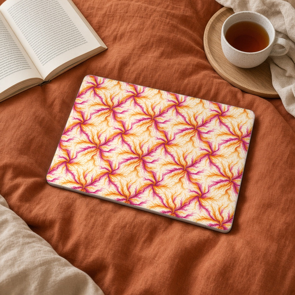 Sunset Ink Branches matte MacBook case on a laptop on rust linen bedding
