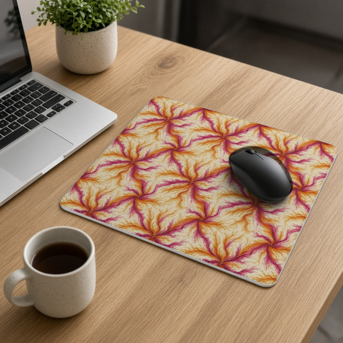 Sunset Ink Branches vegan leather mouse mat on an oak desk with a laptop, mouse and coffee