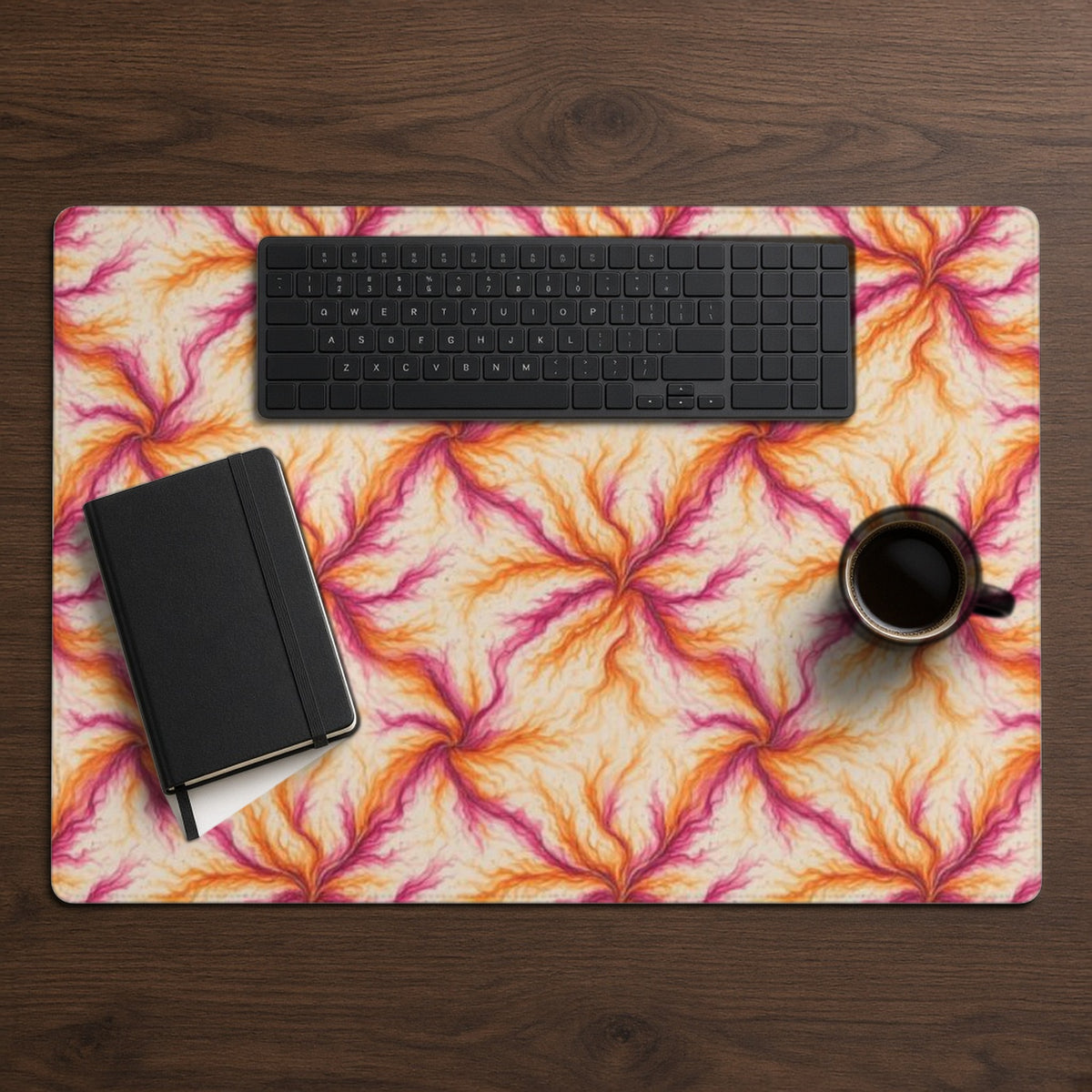 Sunset Ink Branches desk mat from above on walnut with a black keyboard, notebook and coffee