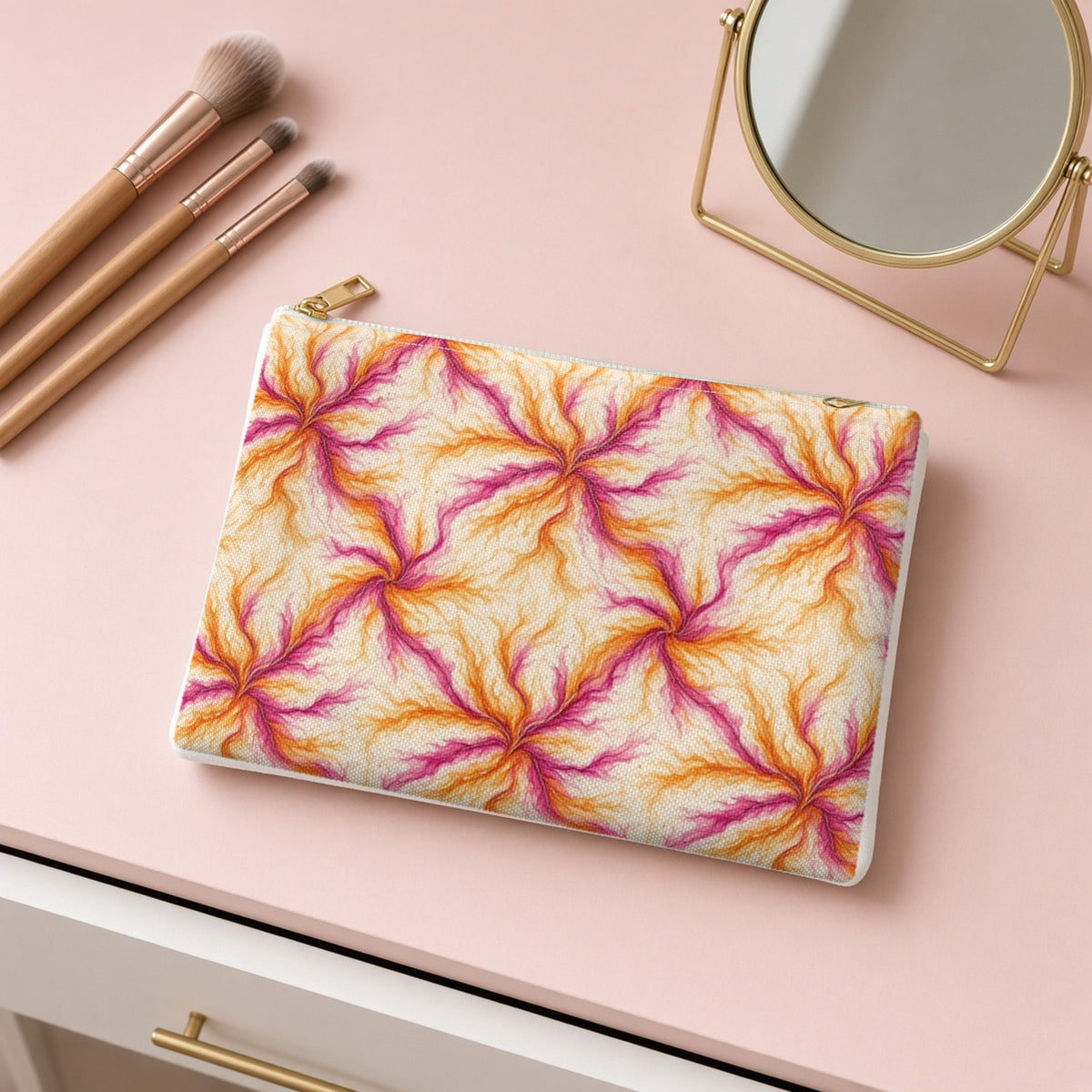 Sunset Ink Branches zip accessory pouch on a pink dressing table with makeup brushes