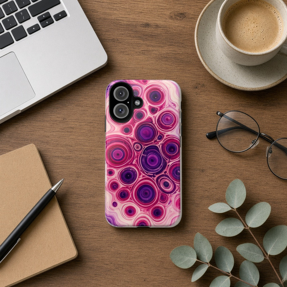 Berry Puddle Pour tough phone case on a wooden desk beside a laptop, coffee and eucalyptus