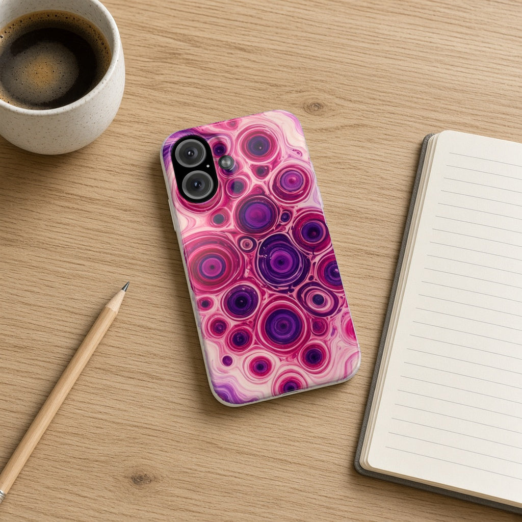Berry Puddle Pour slim phone case on an oak desk with a notebook, pencil and coffee