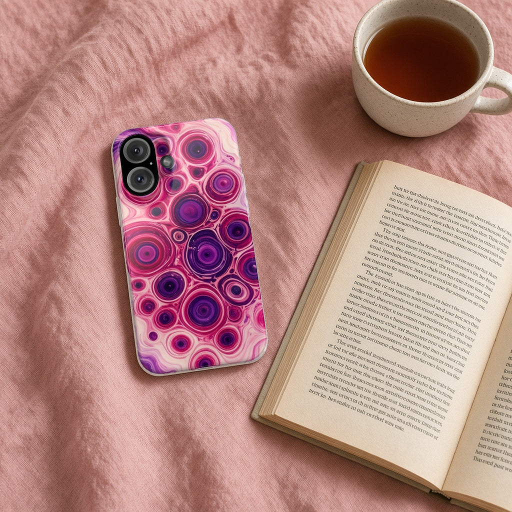 Berry Puddle Pour slim phone case on a pink bedspread with a book and tea