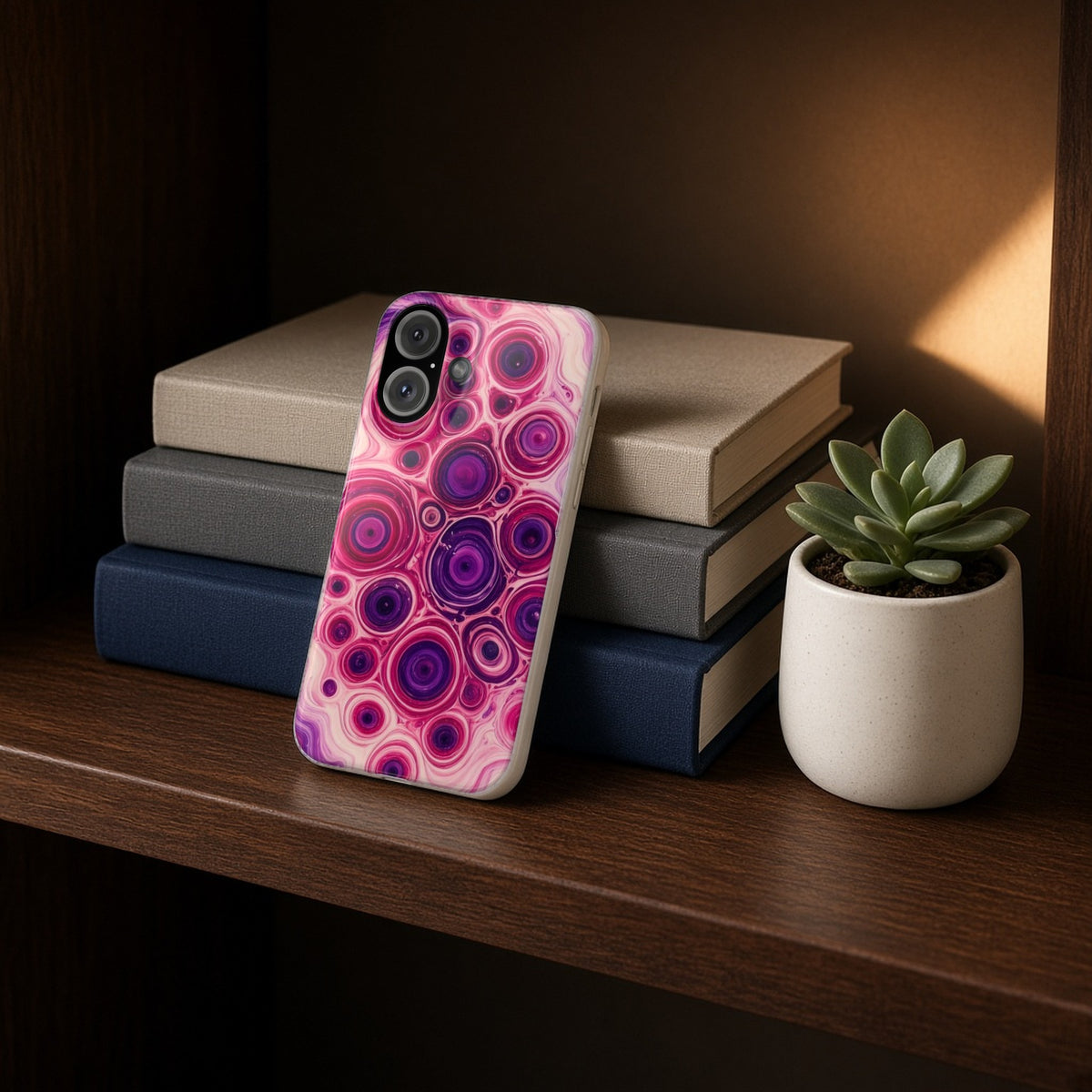 Berry Puddle Pour slim phone case propped on a bookshelf beside a small plant
