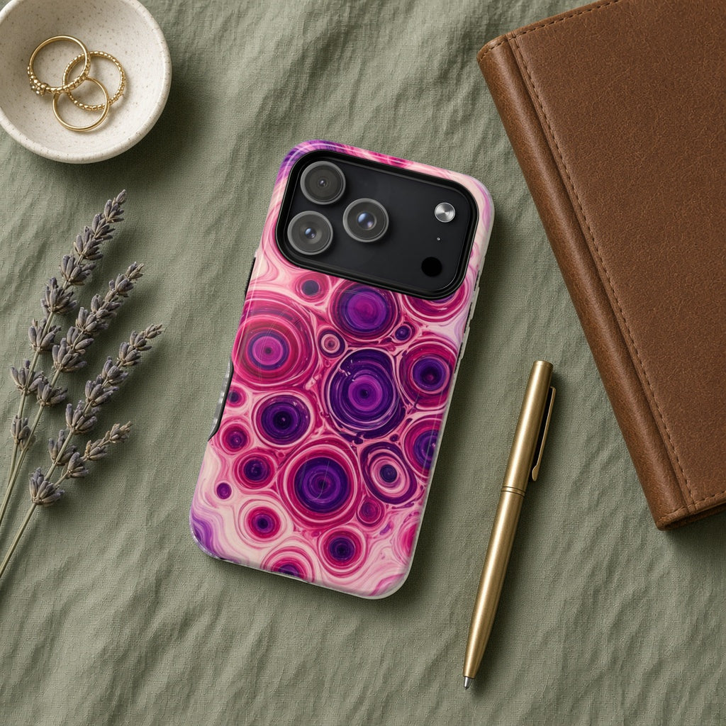 Berry Puddle Pour magnetic iPhone case flat lay on sage linen with a notebook and pen