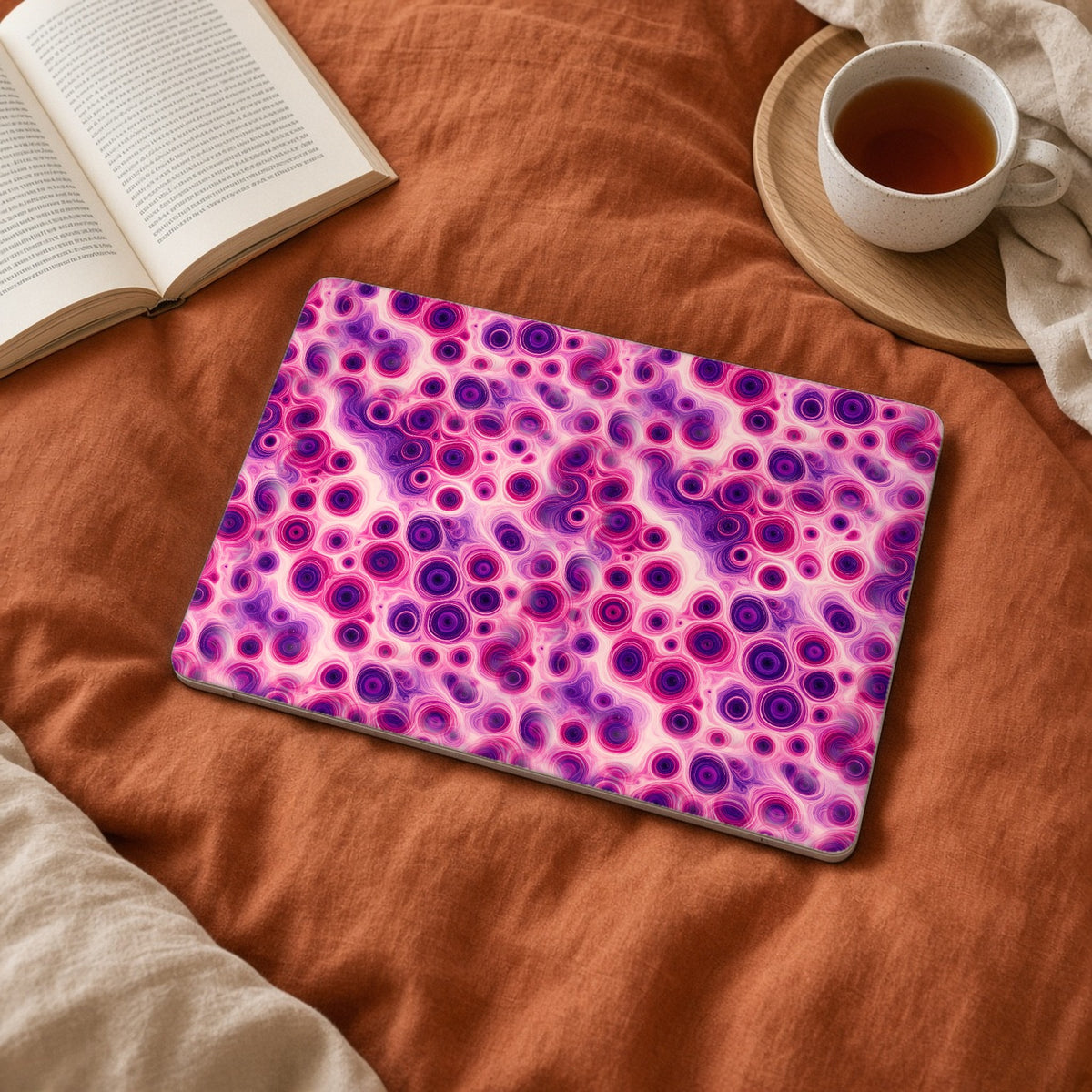 Berry Puddle Pour matte MacBook case on a laptop on rust linen bedding