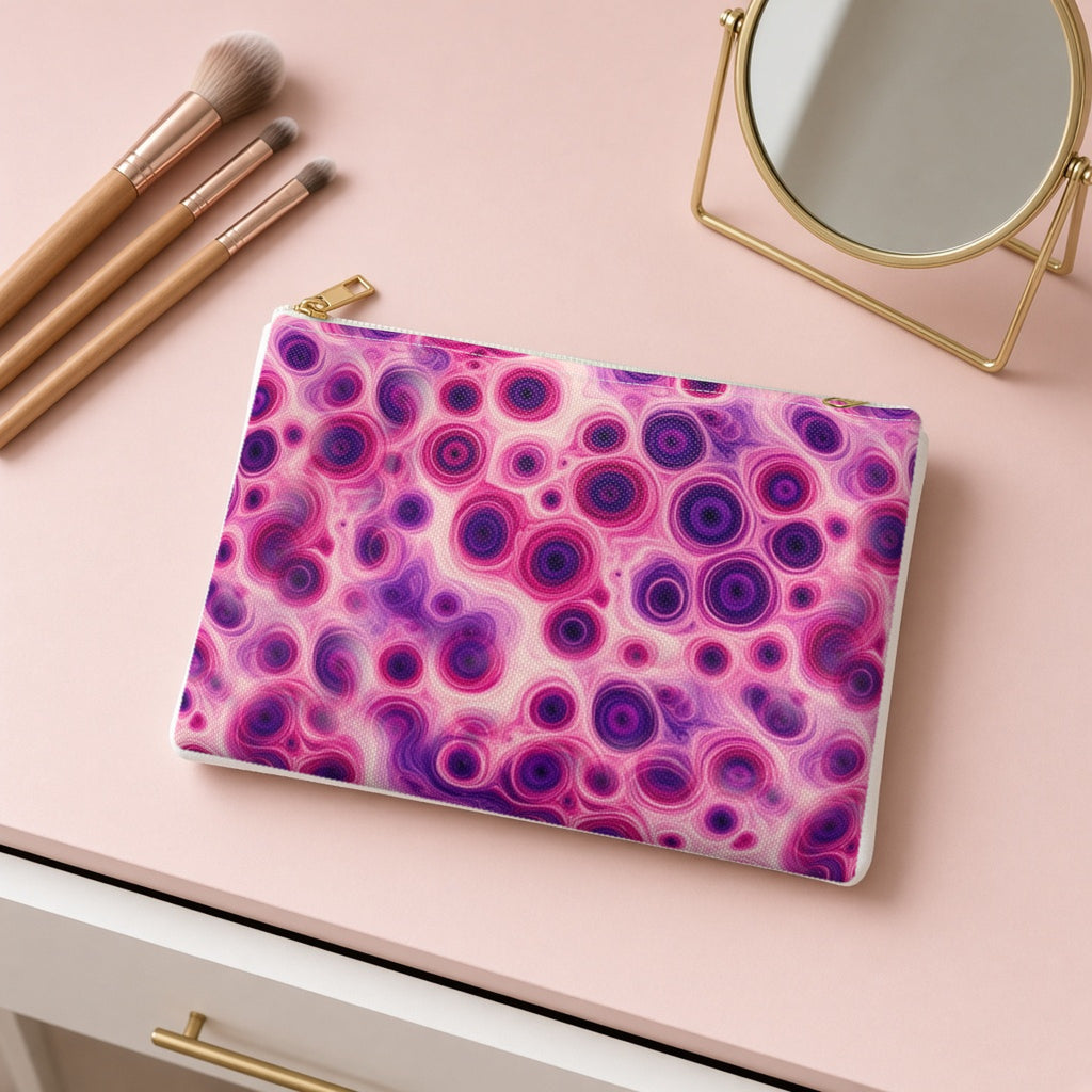 Berry Puddle Pour zip accessory pouch on a pink dressing table with makeup brushes