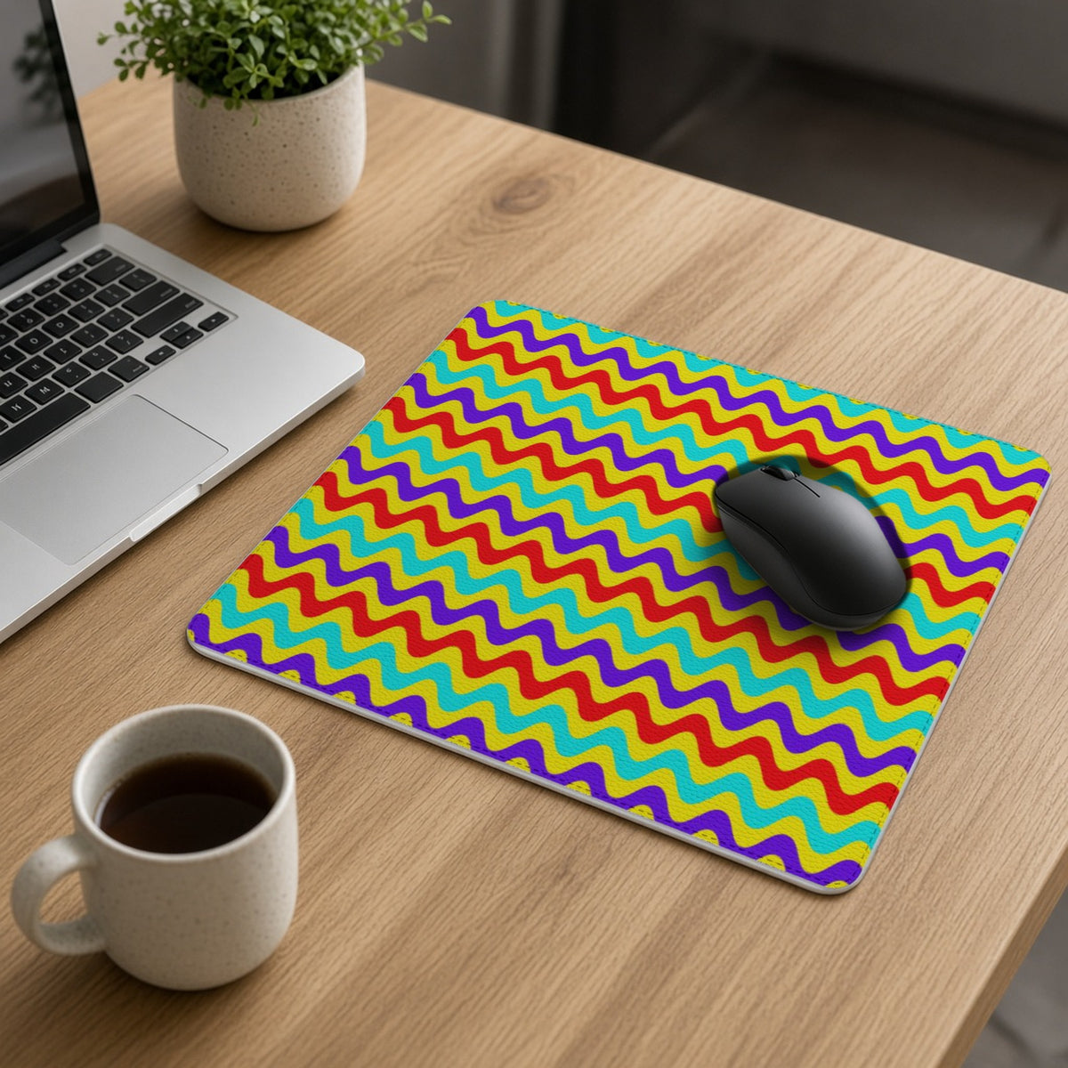 Big Ripple Chevrons vegan leather mouse mat on an oak desk with a laptop, mouse and coffee