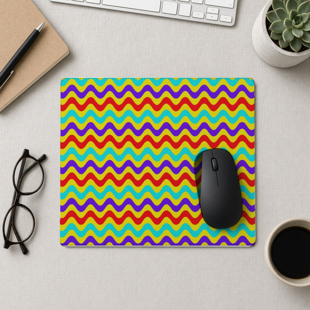 Big Ripple Chevrons vegan leather mouse mat from above with a mouse, notebook and glasses