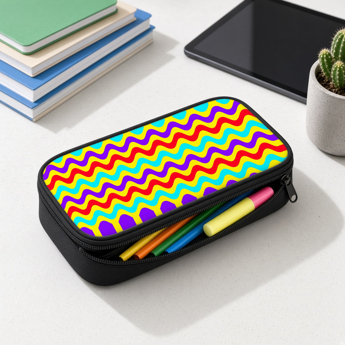 Big Ripple Chevrons pencil case open with colourful pens and highlighters on a white desk