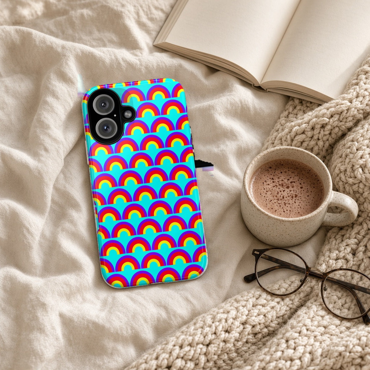 Chromatic Scallop Ripple tough phone case on a cosy knit blanket with a hot chocolate and glasses
