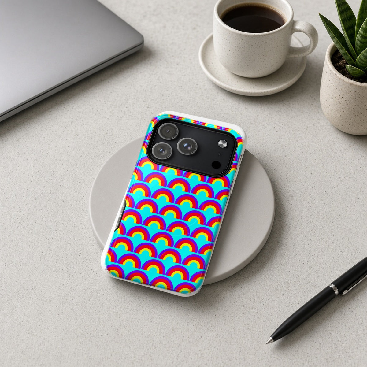 Chromatic Scallop Ripple magnetic iPhone case on a wireless charging pad on a grey desk