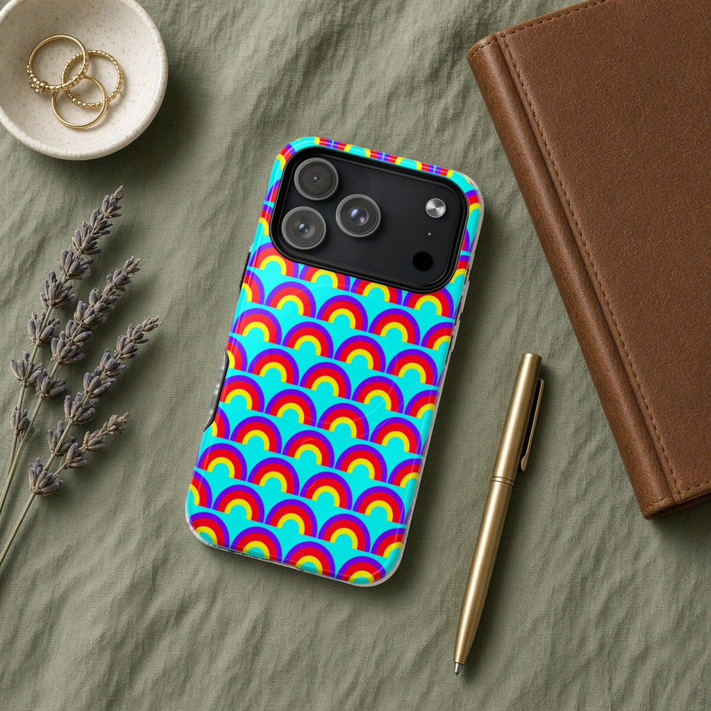 Chromatic Scallop Ripple magnetic iPhone case flat lay on sage linen with a notebook and pen