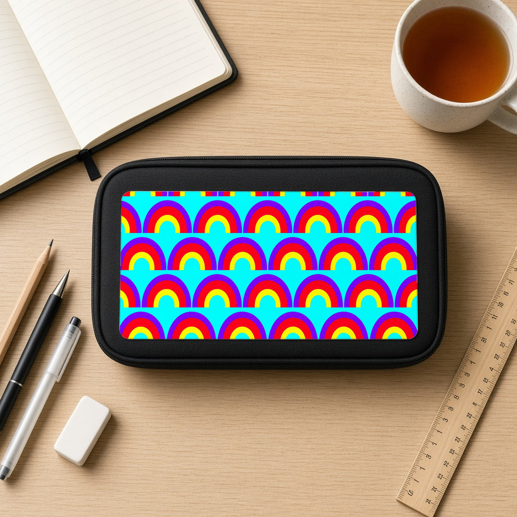 Chromatic Scallop Ripple pencil case on a wooden desk with notebook, pens and a cup of tea