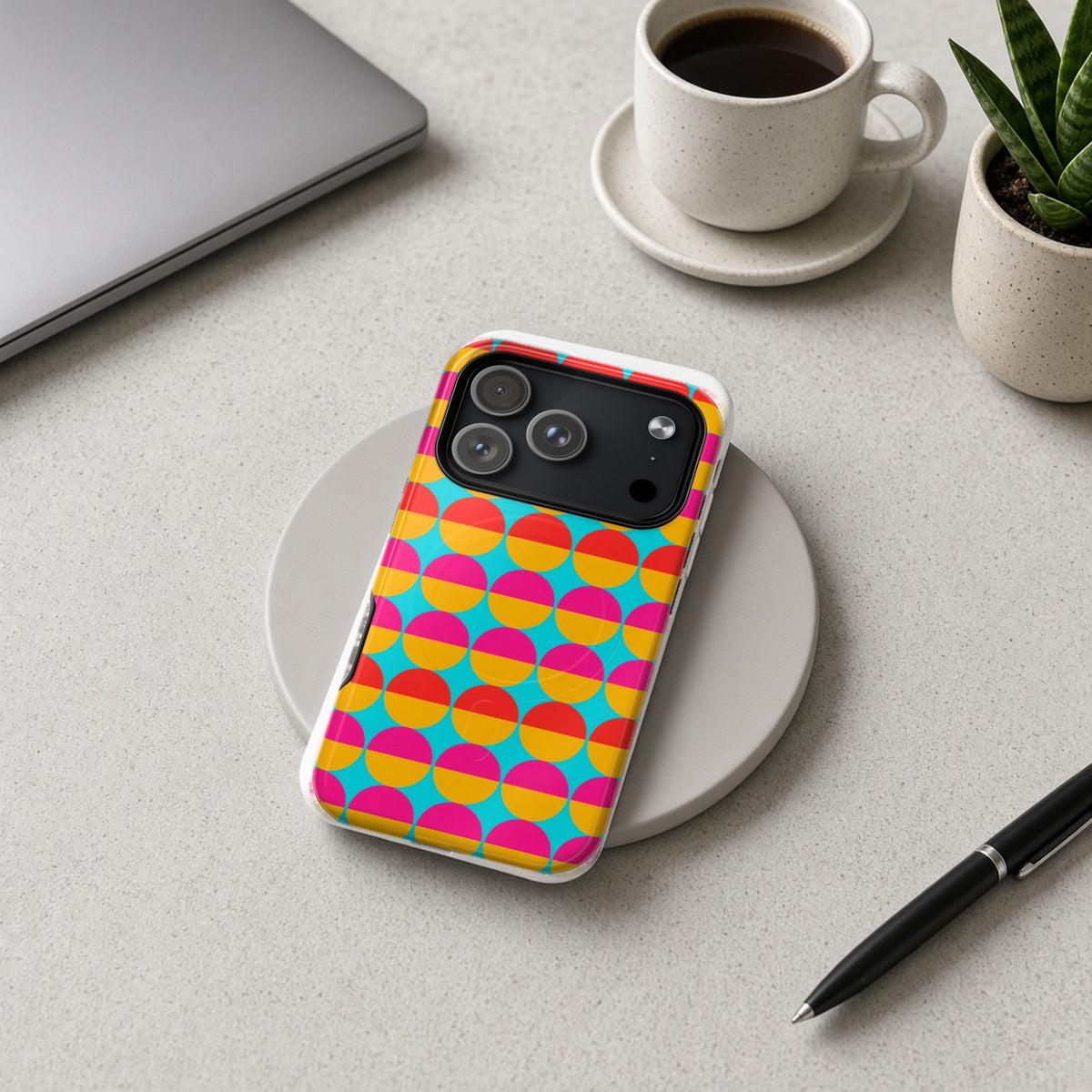 Half-Moon Stack magnetic iPhone case on a wireless charging pad on a grey desk