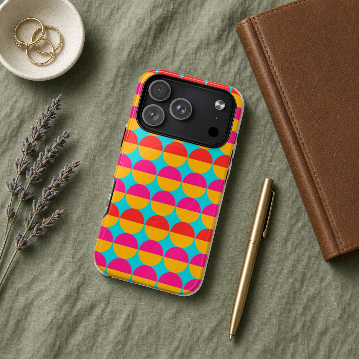 Half-Moon Stack magnetic iPhone case flat lay on sage linen with a notebook and pen
