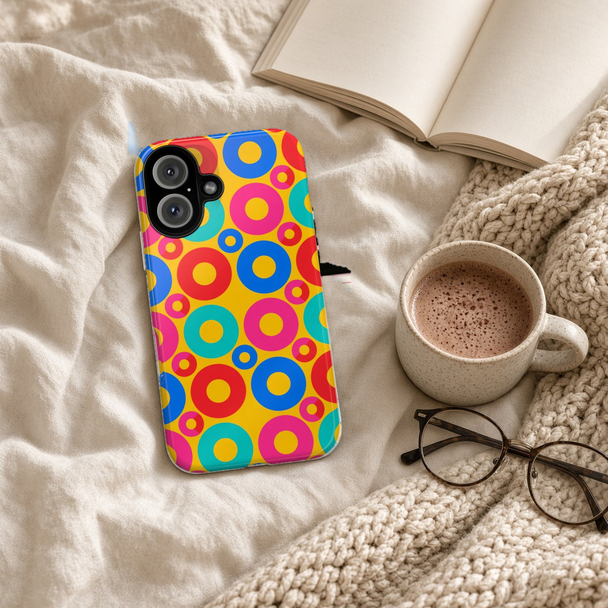 Big Ring Blocks tough phone case on a cosy knit blanket with a hot chocolate and glasses