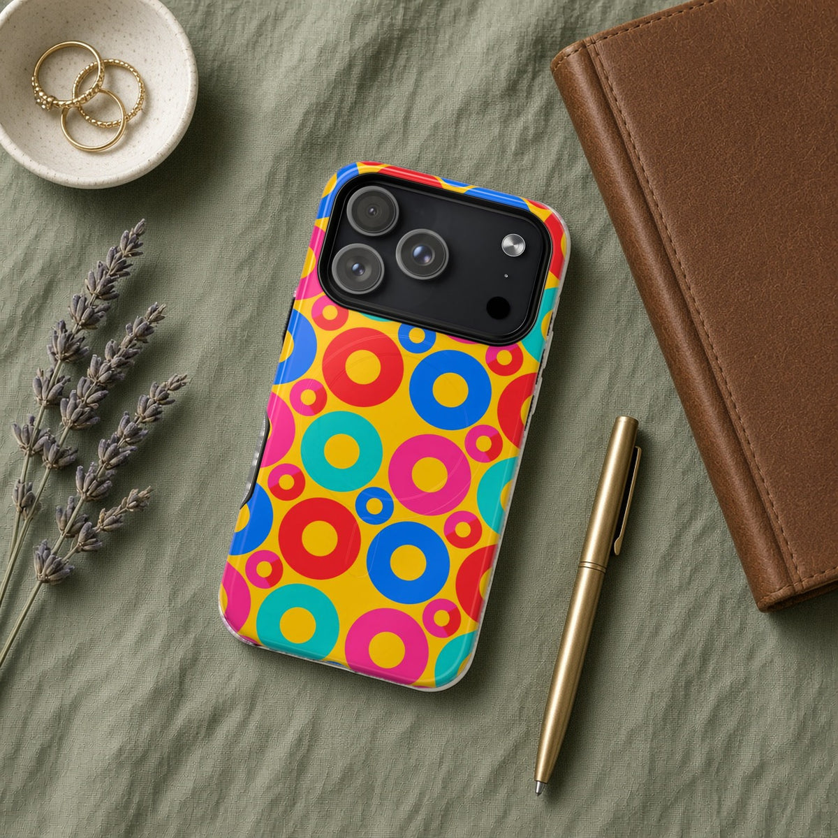 Big Ring Blocks magnetic iPhone case flat lay on sage linen with a notebook and pen
