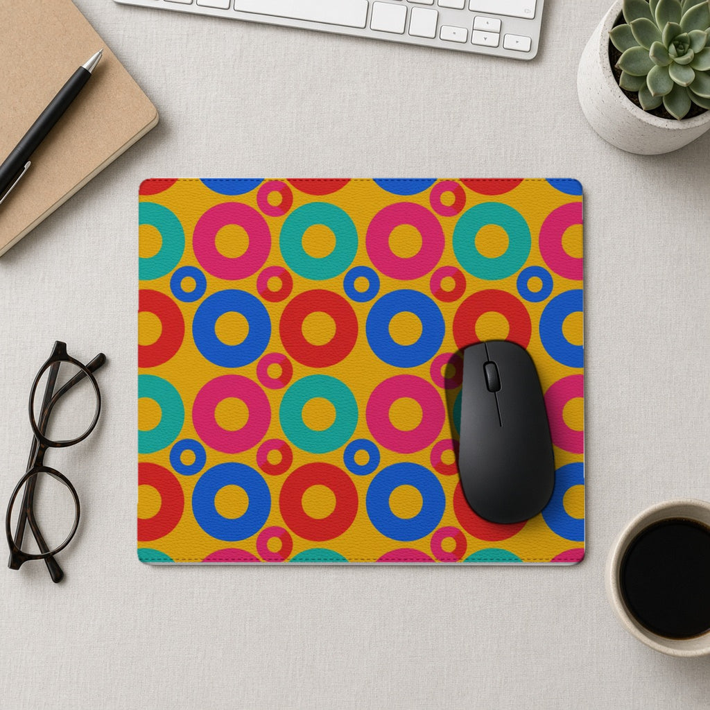Big Ring Blocks vegan leather mouse mat from above with a mouse, notebook and glasses