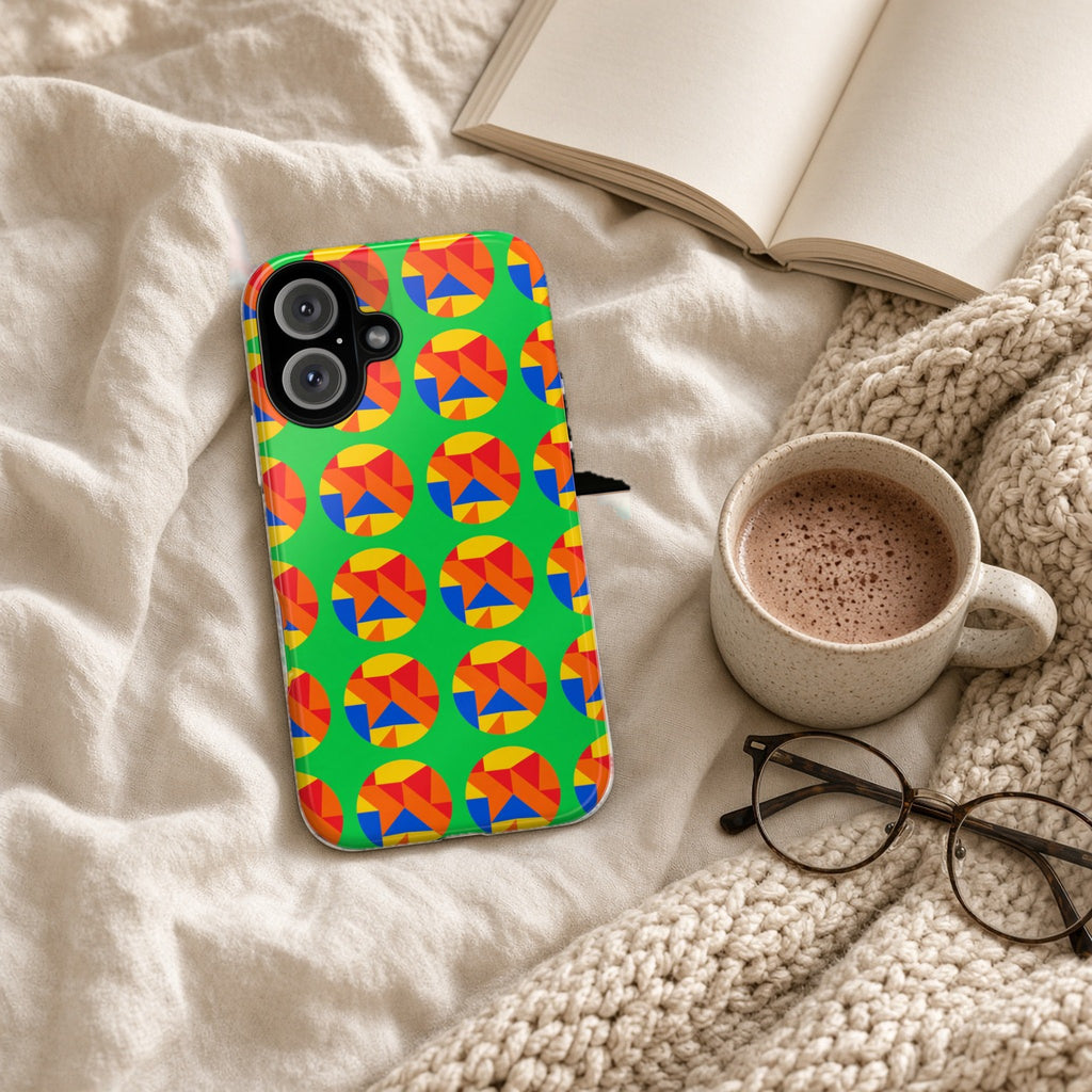 Broken Circle Planes tough phone case on a cosy knit blanket with a hot chocolate and glasses