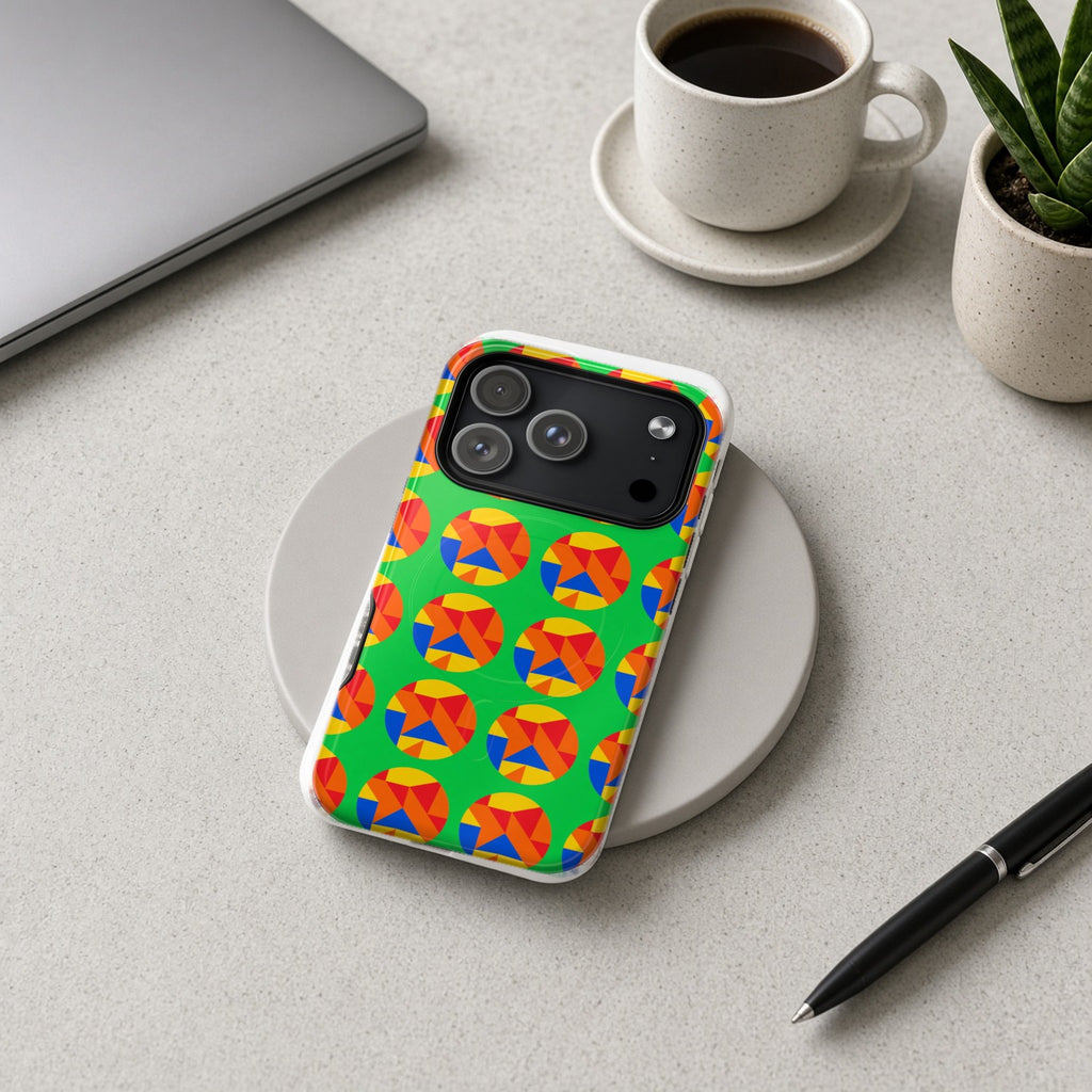 Broken Circle Planes magnetic iPhone case on a wireless charging pad on a grey desk