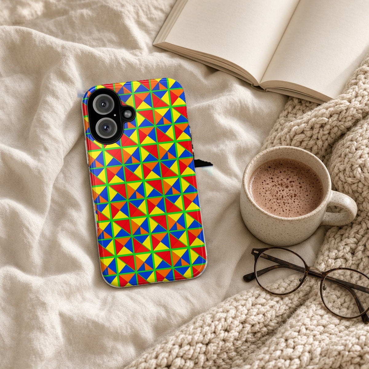 Split Square Fiesta tough phone case on a cosy knit blanket with a hot chocolate and glasses
