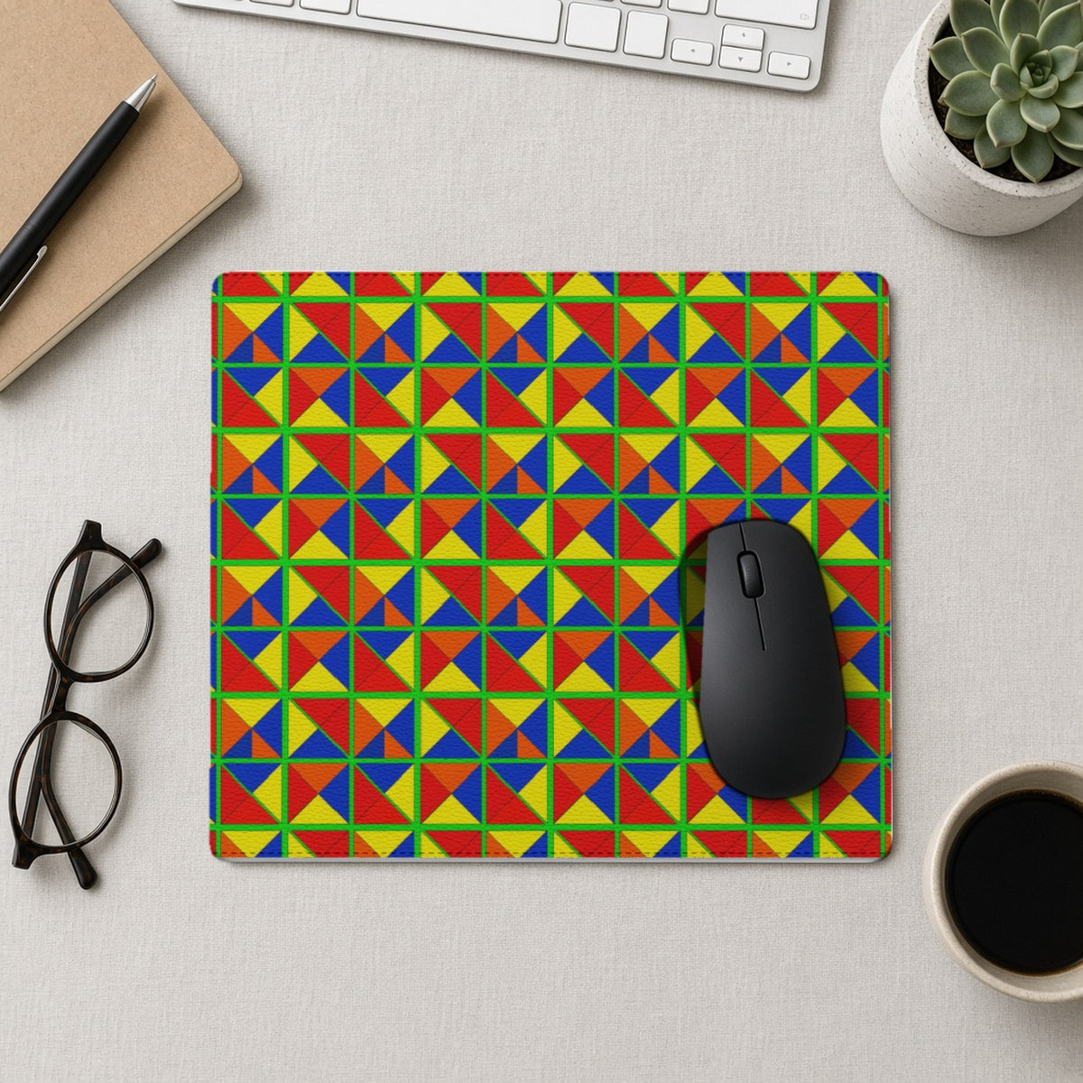 Split Square Fiesta vegan leather mouse mat from above with a mouse, notebook and glasses