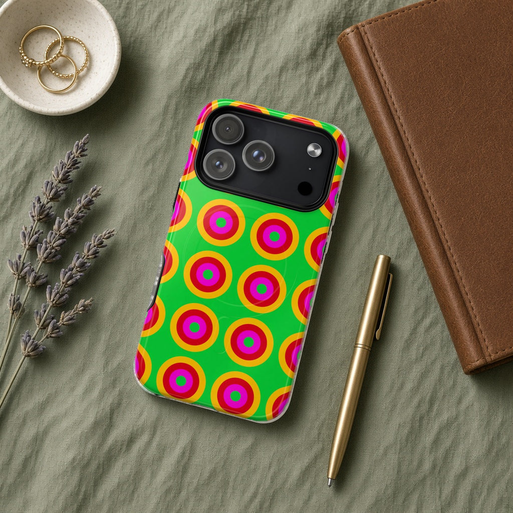 Giant Op-Art Jewel Rings magnetic iPhone case flat lay on sage linen with a notebook and pen