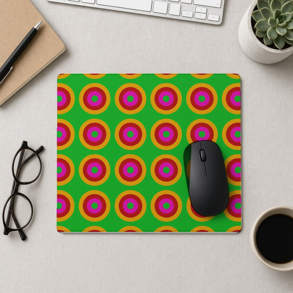 Giant Op-Art Jewel Rings vegan leather mouse mat from above with a mouse, notebook and glasses