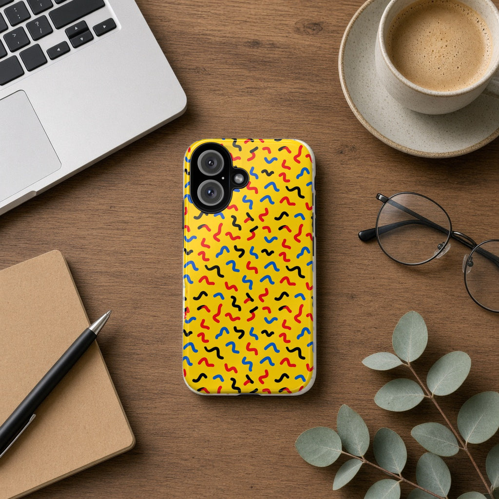 Squiggle Strokes Yellow tough phone case on a wooden desk beside a laptop, coffee and eucalyptus