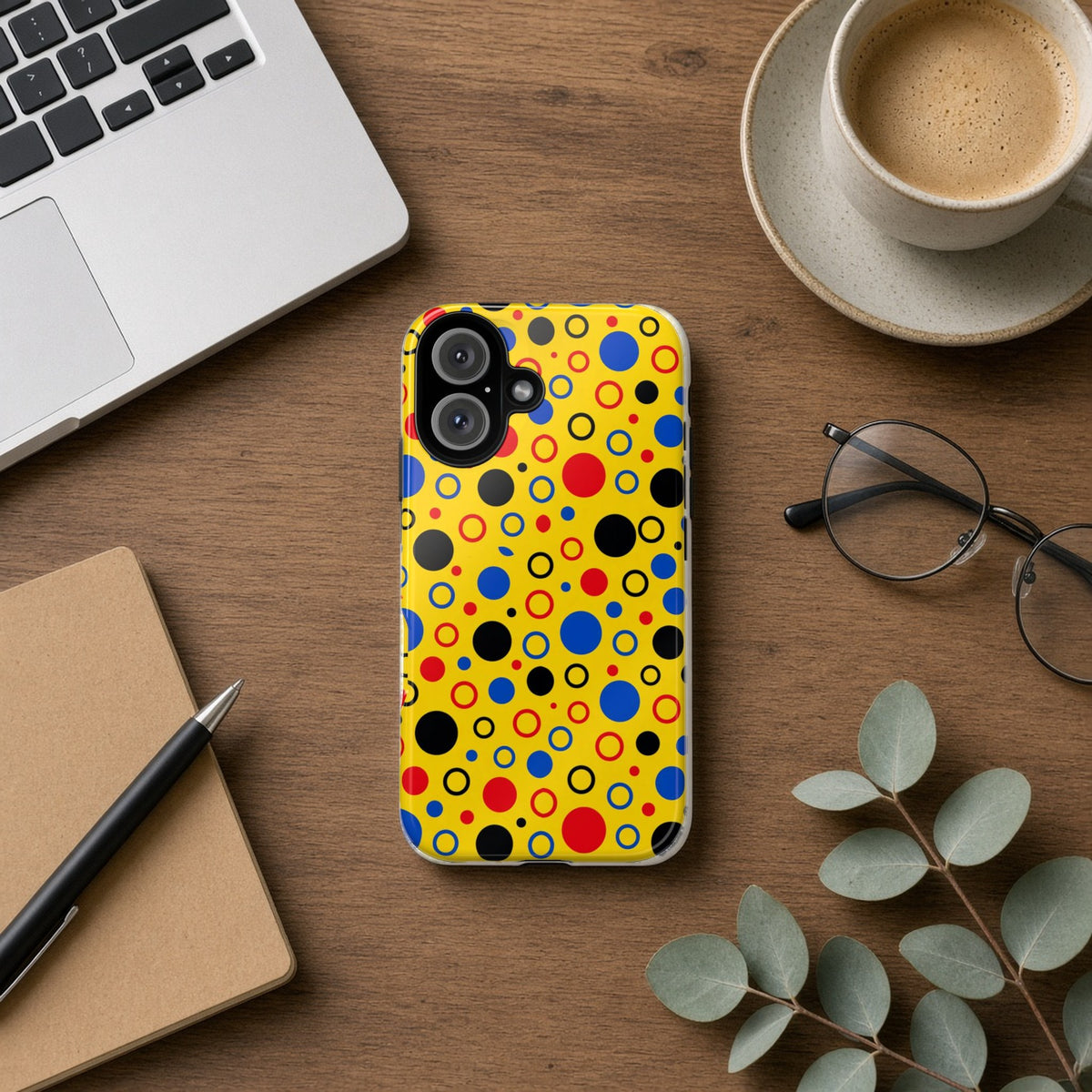 Bubble Outlines tough phone case on a wooden desk beside a laptop, coffee and eucalyptus