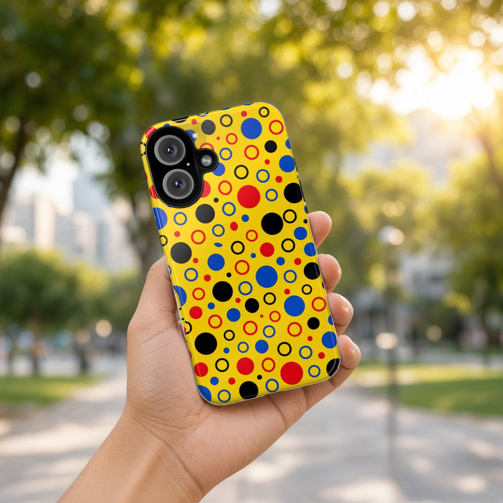 Hand holding the Bubble Outlines tough phone case outdoors in a sunny park