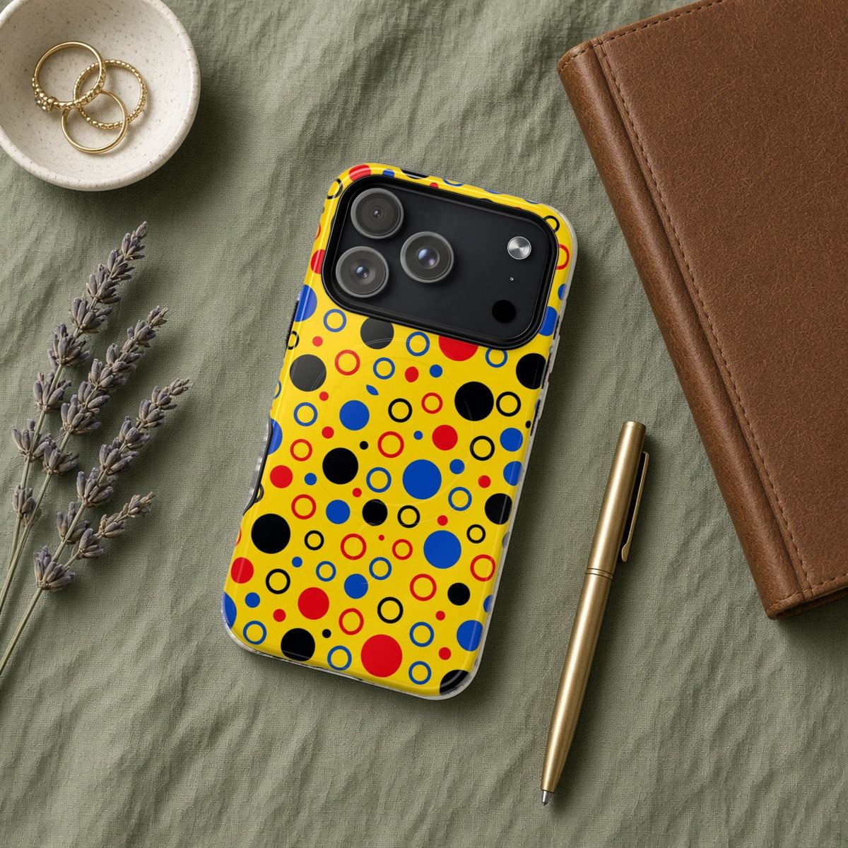 Bubble Outlines magnetic iPhone case flat lay on sage linen with a notebook and pen