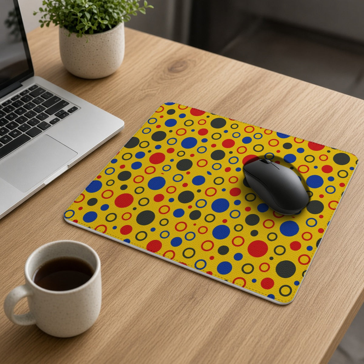 Bubble Outlines vegan leather mouse mat on an oak desk with a laptop, mouse and coffee